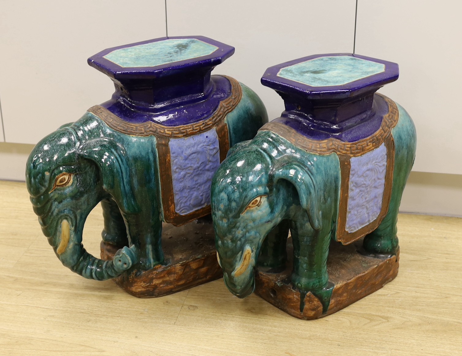 A pair of Chinese Shiwan type polychrome ‘elephant’ tables or stools, 57cm